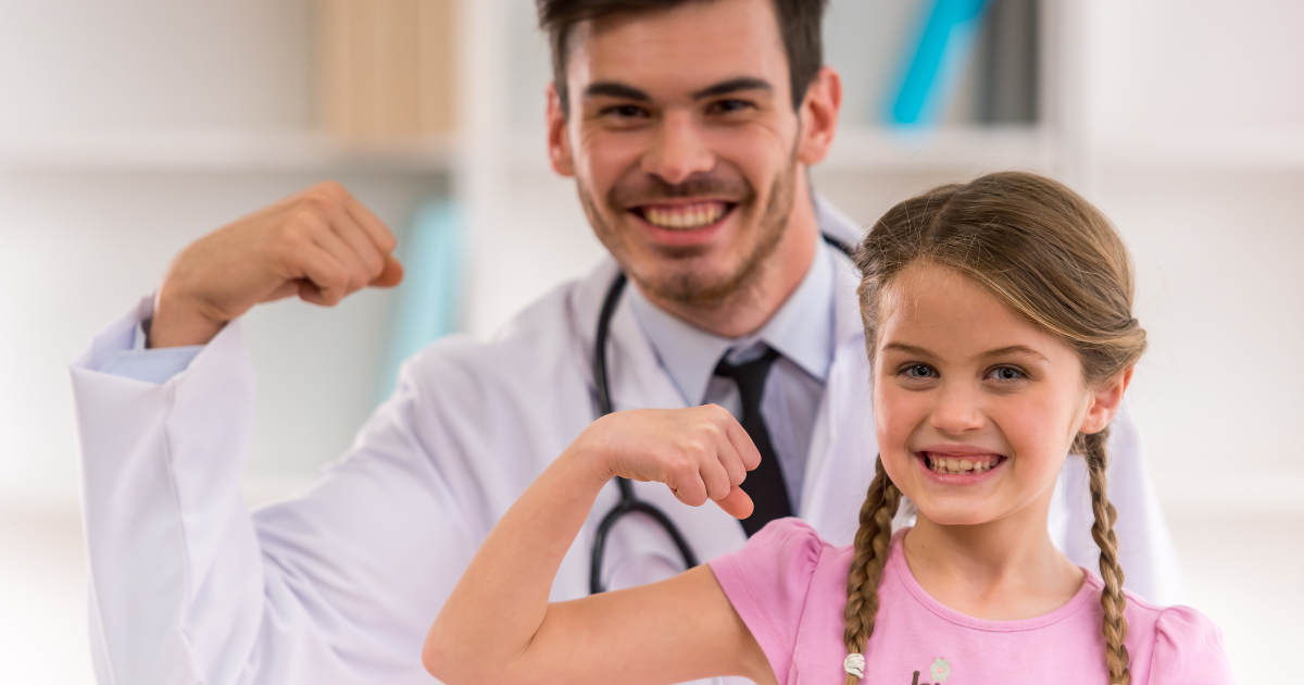 Smiling doctor and child celebrating progress during growth hormone therapy checkup in a supportive pediatric clinic setting.