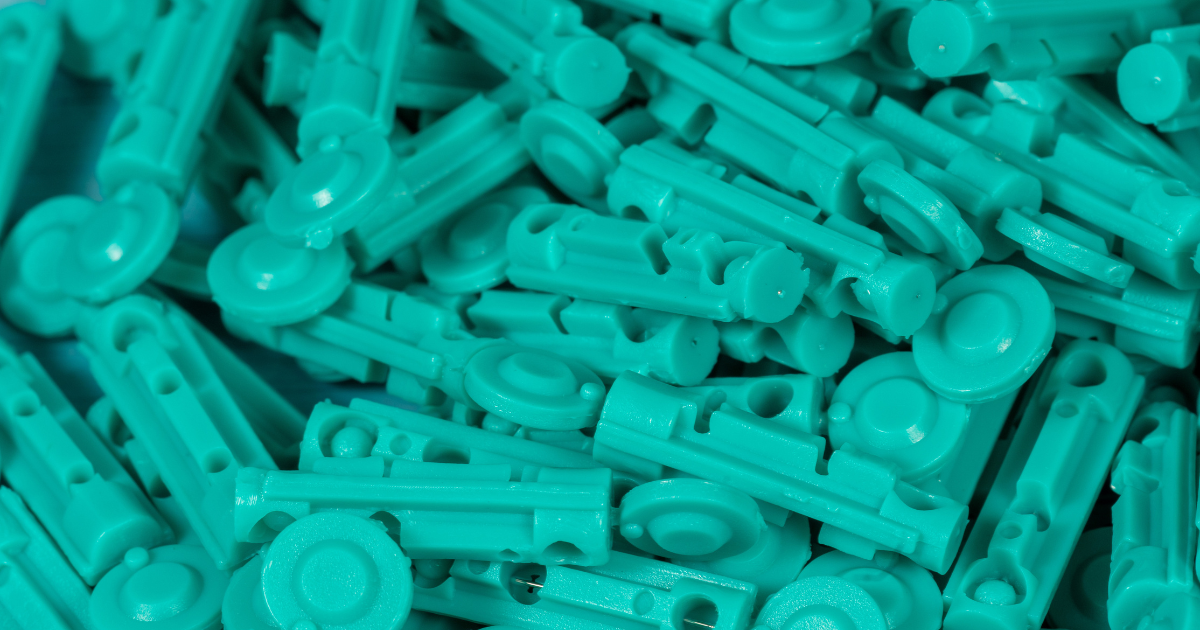 Close-up of a pile of disposable lancets used with lancing devices for safe and comfortable blood glucose testing.