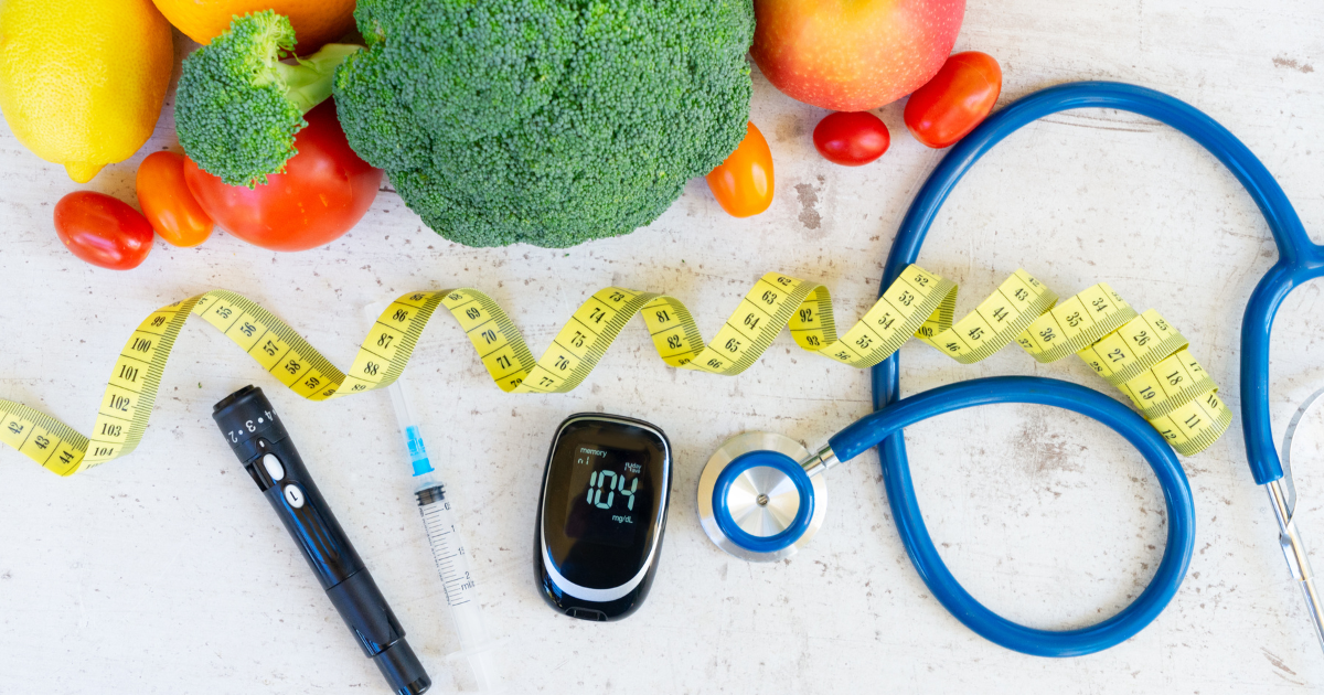 Arrangement of vegetables, stethoscope, and glucose monitor symbolizing healthy snacks for diabetics and balanced nutrition choices.